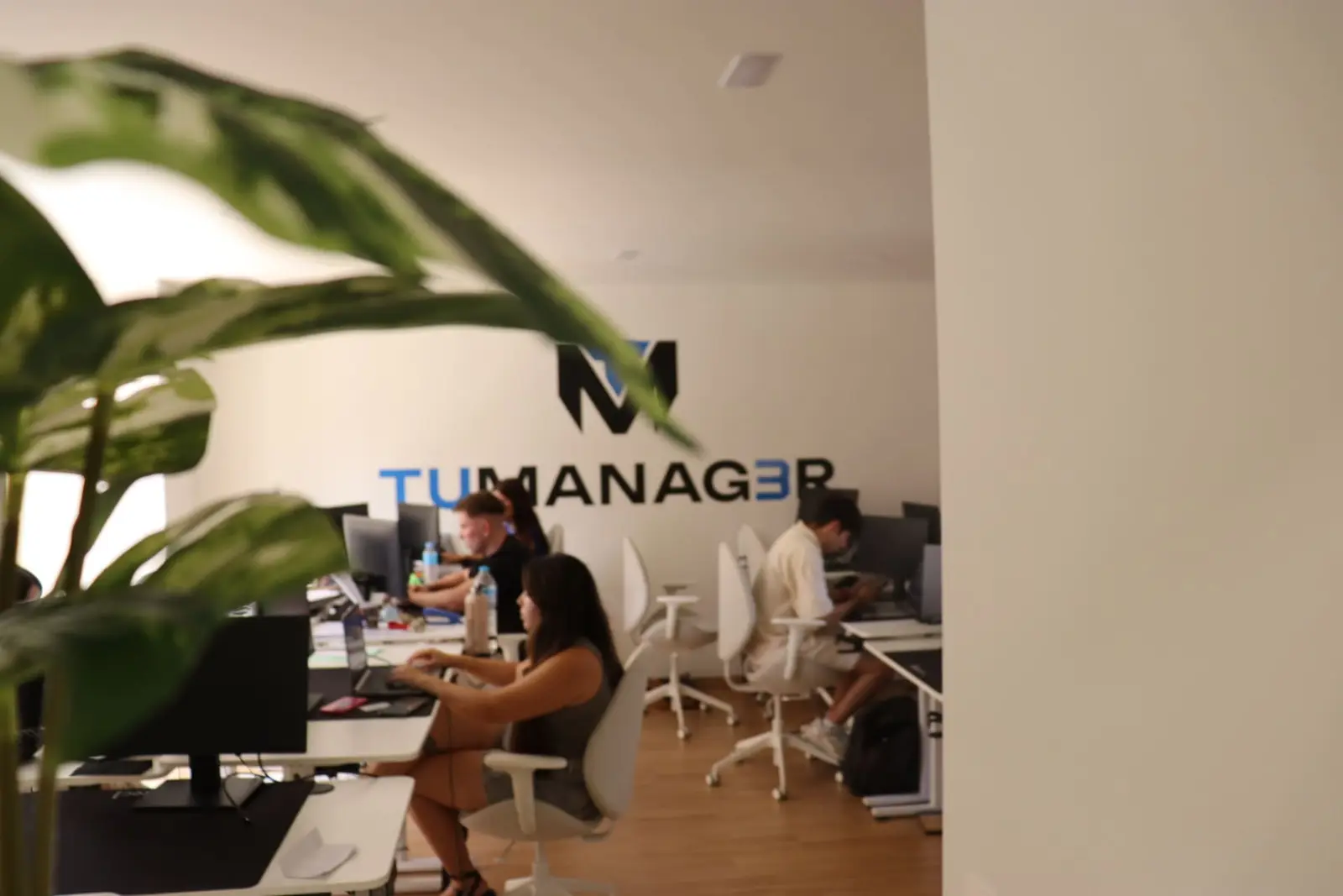 TuManag3r office in Málaga, with plants and the team working in the background