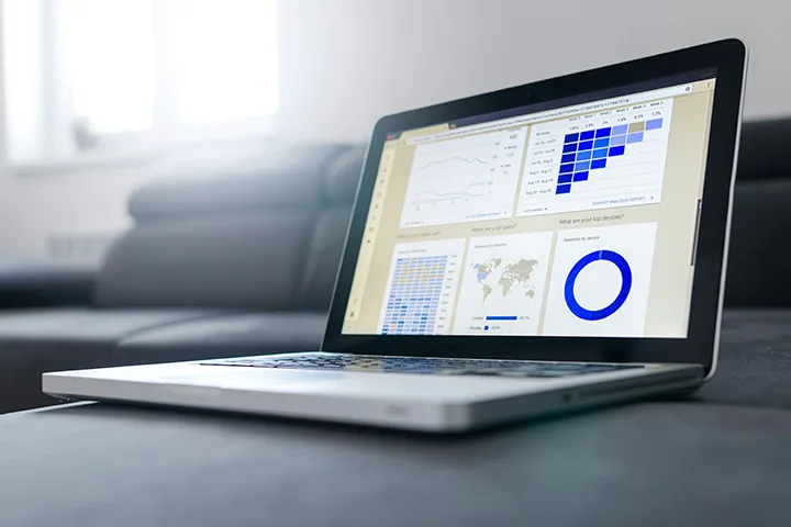 Open laptop displaying charts and tables on its screen