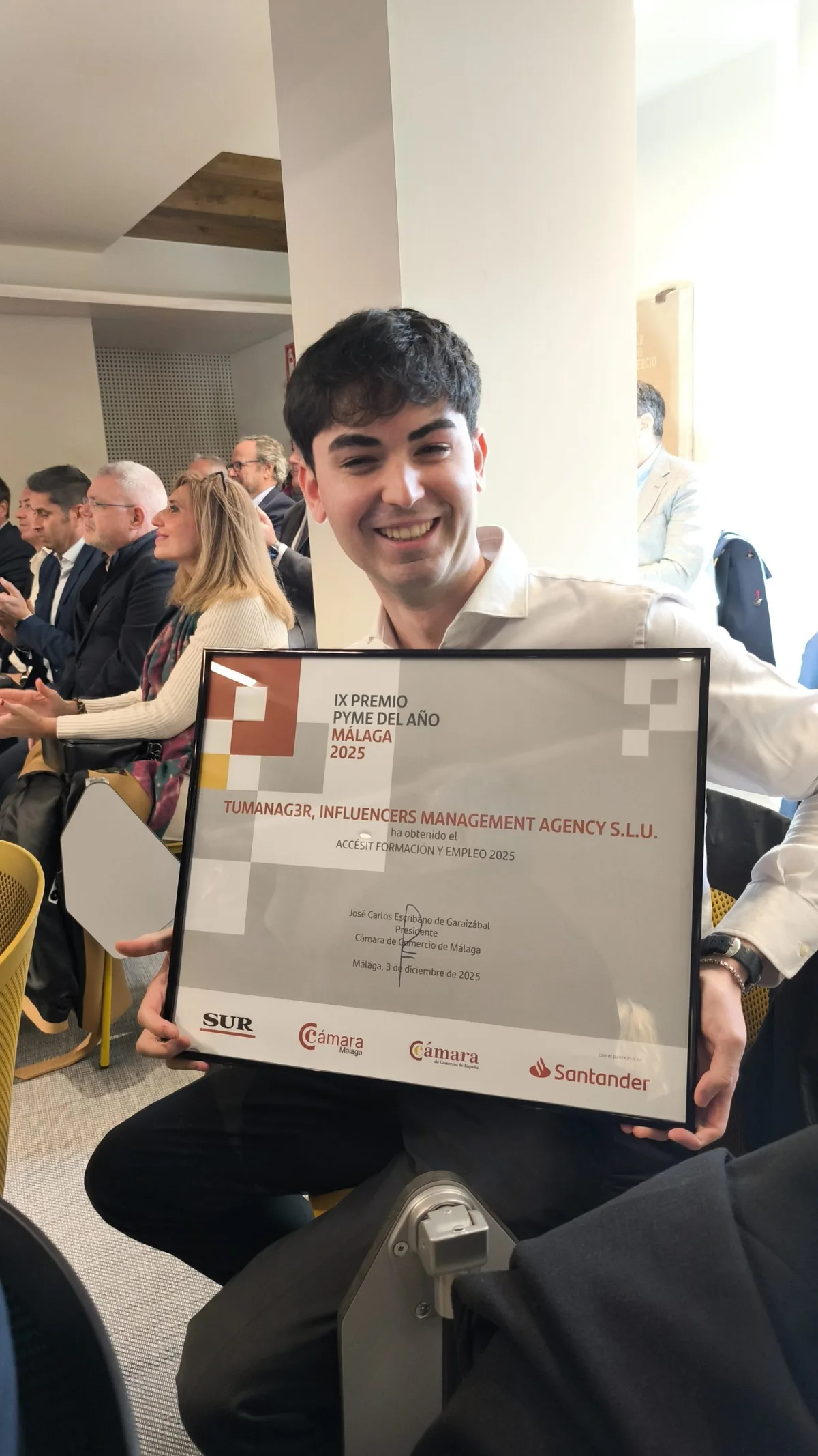 Man holds TuManag3r's runner-up certificate for the 2025 Málaga SME of the Year award