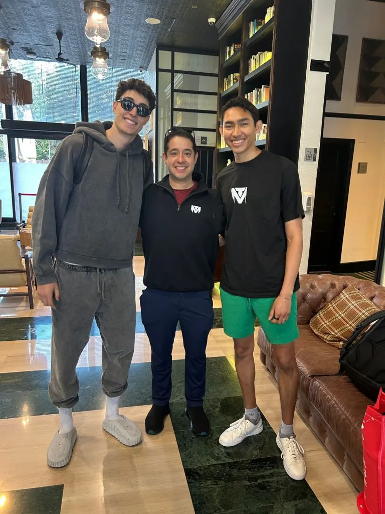 Three men pose together wearing TuManag3r clothing