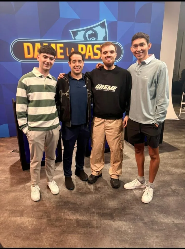 Four men pose in front of the Dame la pasta set